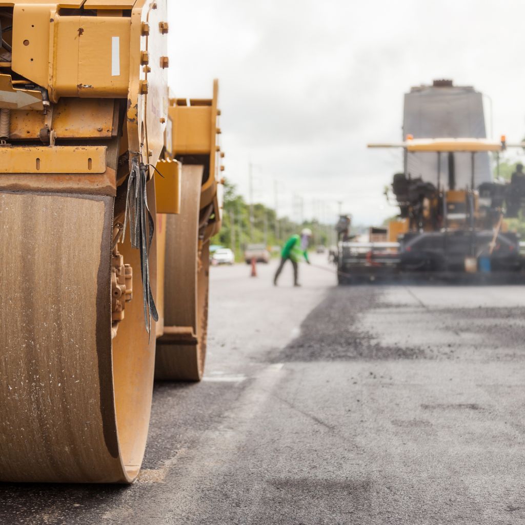 Road roller compacting an asphalt pavement layer